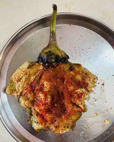 grilled and spiced big green brinjal (egg plant)