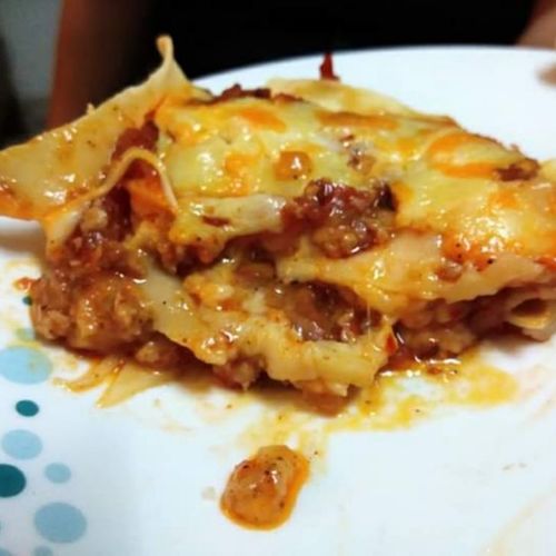 Hand rolled lasagna sheets between chicken