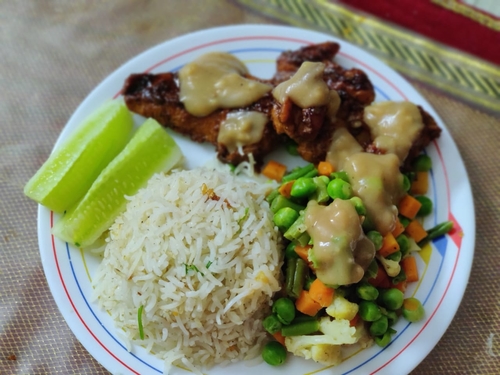 Chicken steak meal with garlic rice and stir fried vegetables -continental cuisine