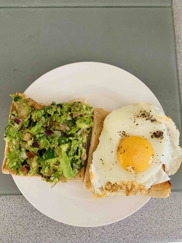 Bread toast with guacamole and egg